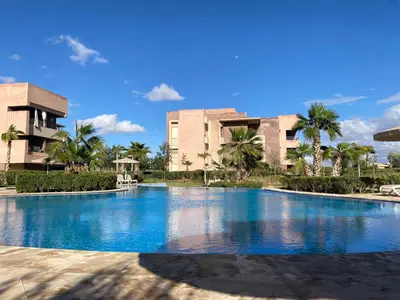 a large swimming pool in front of a building at appartement à prestigia golf marrakech- SAPHIR in Marrakech