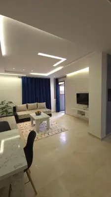 a living room with a couch and a table at Charming Marrakech Appartement in Marrakech