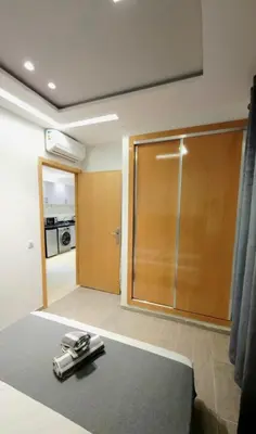 a room with a sliding glass door and a kitchen at Charming Marrakech Appartement in Marrakech