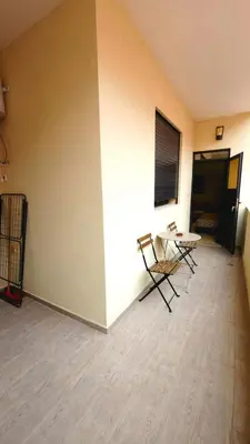 a room with two chairs and a table and a wall at Charming Marrakech Appartement in Marrakech