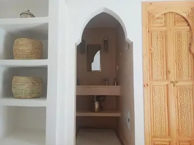 a bathroom with a sink and a mirror at Riad DabaKech in Marrakech