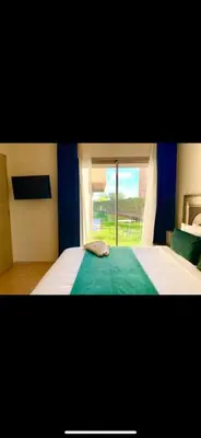 a bedroom with a large bed and a window at Marrakech Prestigia golf city in Marrakech