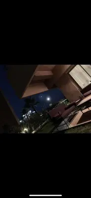 a night view of a building with chairs in a yard at Marrakech Prestigia golf city in Marrakech