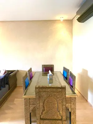 a dining room table with chairs and a couch at Marrakech Prestigia golf city in Marrakech
