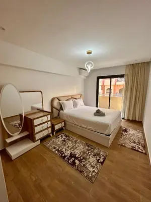a bedroom with a bed with a mirror and a dressing table at Appartement à Marrakech 2 chambres avec piscine et parking Palmeraie Gates in Marrakech