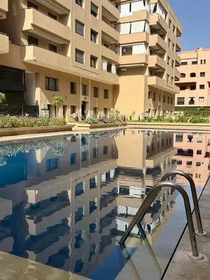 a swimming pool in front of a building at Appartement à Marrakech 2 chambres avec piscine et parking Palmeraie Gates in Marrakech