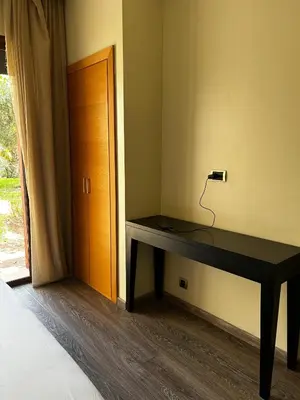 a desk in the corner of a room with a door at Vizir Center Apartment Marrakech A103 in Marrakech
