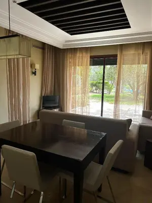 a living room with a table and chairs and a couch at Vizir Center Apartment Marrakech A103 in Marrakech