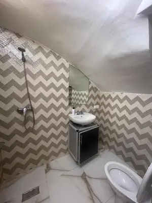 a bathroom with a sink and a mirror at Cozy Part in Marrakech