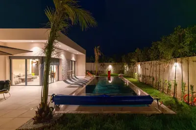 a pool in the backyard of a house at night at Villa Wimiliim - Piscine et jardin Privée Sans vis-à-vis Wifi HD in Segraga