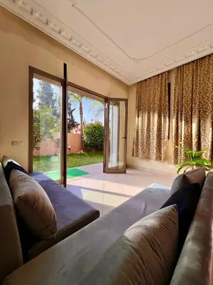 a living room with a couch and a large window at Villa with private pool in the center of marrakech in Marrakech