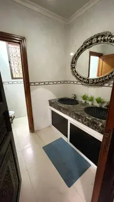 a bathroom with two sinks and a mirror at Villa with private pool in the center of marrakech in Marrakech