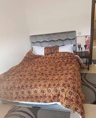a bedroom with a bed with a large bedspread and pillows at Chicafrik in Marrakech