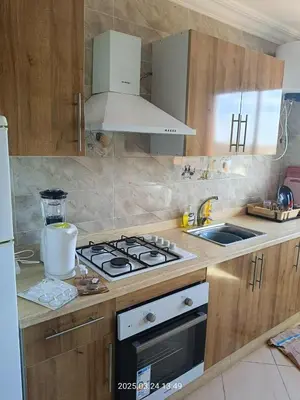 a kitchen with a stove top oven and a sink at Chicafrik in Marrakech