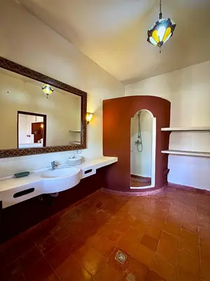 a bathroom with a sink and a mirror at Domaine JJ in Marrakech