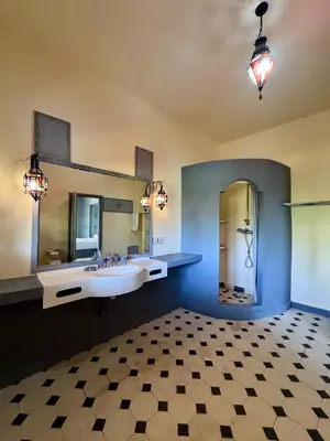a large bathroom with a sink and a mirror at Domaine JJ in Marrakech