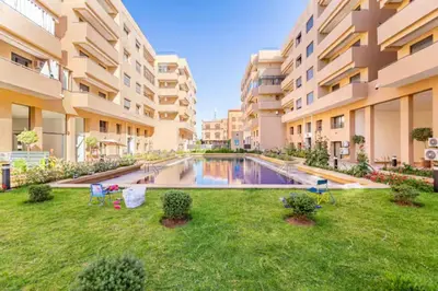 an apartment yard with a swimming pool in a building at Résidence palmeraie gates Marrakech in Marrakech