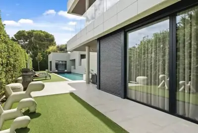 a house with a yard with a pool and grass at Beautiful palm tree villa in Marrakech