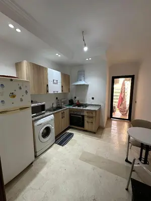 a kitchen with a white refrigerator and a dishwasher at Appartement a Marrakech centre in Marrakech