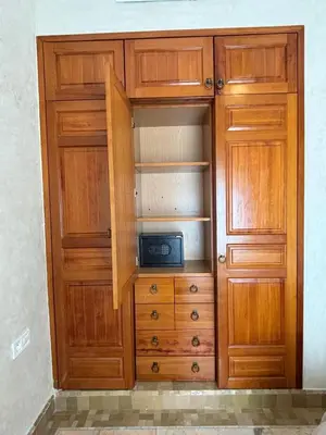 a wooden cabinet with a microwave in it at Palmeraie village , lieu exceptionnel avec jardin et piscine in Marrakech