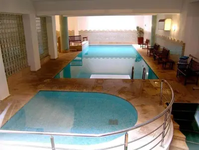 a large swimming pool in a building at apartement centre gueliz in Marrakech