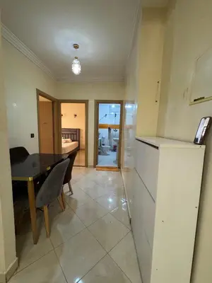 a kitchen and dining room with a table and a refrigerator at 2BR w Balcony in Gueliz 2 Bedroom Apartment with Balcony in Gueliz in Marrakech