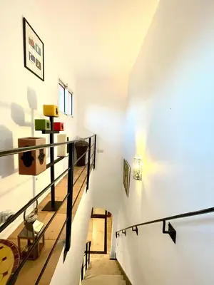 a staircase in a room with white walls at Rooftop Sun Pool Chic Apartment Perfect Stay in Marrakech