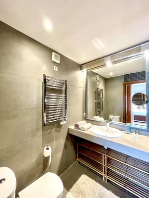 a bathroom with a sink and a toilet and a mirror at Rooftop Sun Pool Chic Apartment Perfect Stay in Marrakech