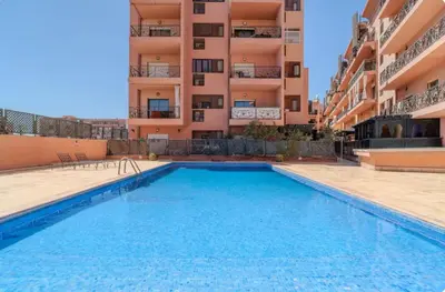 a swimming pool in front of a building at Rooftop Sun Pool Chic Apartment Perfect Stay in Marrakech