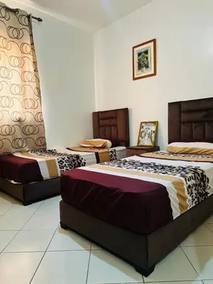 a room with three beds in a room at Appartement a louer in Marrakech