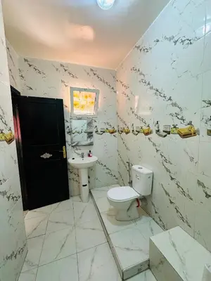 a bathroom with a toilet and a sink at Appartement a louer in Marrakech