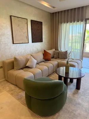 a living room with a couch and a table at Elegant Apartment in Prestigia Pool & Golf in Marrakech