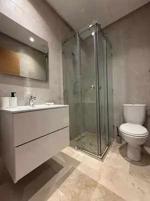 a bathroom with a shower and a toilet and a sink at Elegant Apartment in Prestigia Pool & Golf in Marrakech
