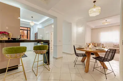 a kitchen and dining room with a table and chairs at NEW Cocon cosy au coeur de Marrakech in Marrakech