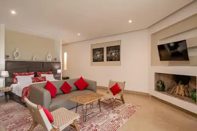 a bedroom with a couch and a bed and a fireplace at Villa Sofya Domaine exceptionnel 10 suites & piscine privée in Marrakech
