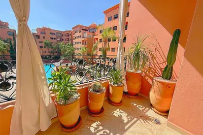 a group of potted plants sitting on a balcony at Menara Palms Marrakech in Marrakech
