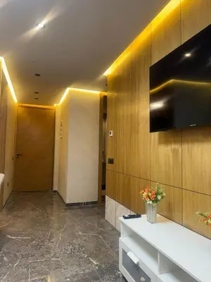 a lobby with a reception desk and a television at Appartement cozy et central, Marrakech in Marrakech