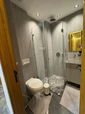 a bathroom with a toilet and a glass shower at Appartement cozy et central, Marrakech in Marrakech
