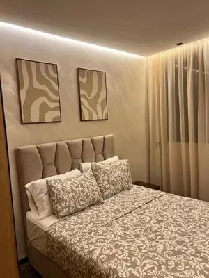 a bedroom with a bed with two pillows on it at Appartement cozy et central, Marrakech in Marrakech