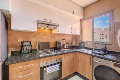 a kitchen with a sink and a dishwasher at Luxury Apartment - Prestigia Golf City Marrakech in Marrakech