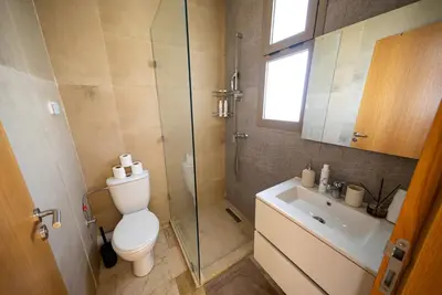 a bathroom with a toilet and a shower and a sink at Prestigia Apartment Secure Residence Pool in Marrakech