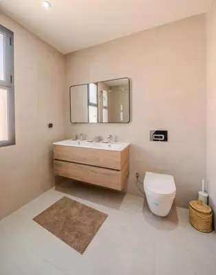 a bathroom with a sink and a toilet and a mirror at Villa Assia Modern Luxury Private Pool in Marrakech