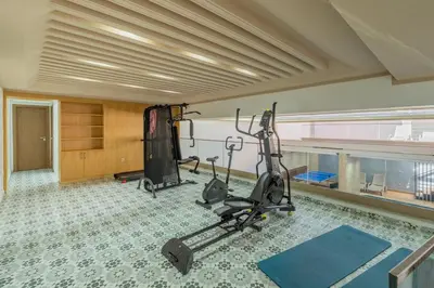 a gym with exercise equipment in a room at Rooftop piscine-new appartment - centre ville in Marrakech