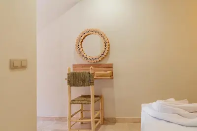 a mirror sitting on top of a table with a chair at Rooftop piscine-new appartment - centre ville in Marrakech