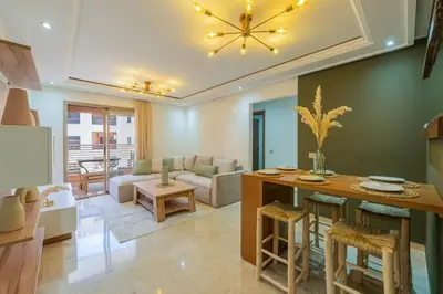 a living room with a table and a couch at Rooftop piscine-new appartment - centre ville in Marrakech
