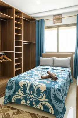 a bedroom with a bed with a blue comforter at Kridarek - Appartement d'exception à Marrakech in Marrakech