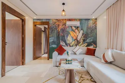 a living room with a couch and a painting on the wall at 2BR NEW Luxury apartment CityCenter in Marrakech