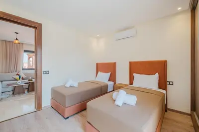 a bedroom with two beds and a mirror at 2BR NEW Luxury apartment CityCenter in Marrakech
