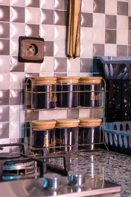 a kitchen counter with pots and pans on a shelf at 5-min away to Marrakech Airport in Marrakech