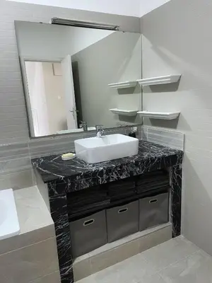 a bathroom with a sink and a mirror at Villa Corail in Marrakech